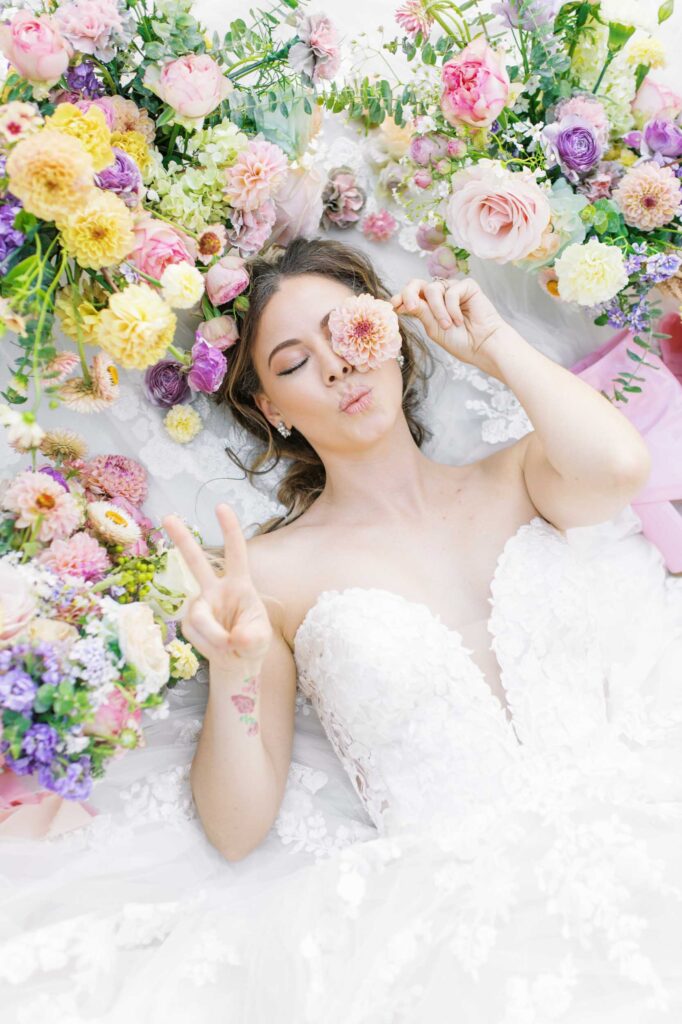 colorful california bridal session laying in flowers
