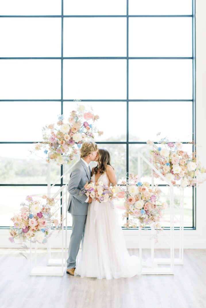 arlo austin wedding kiss at the altar with massive spring florals