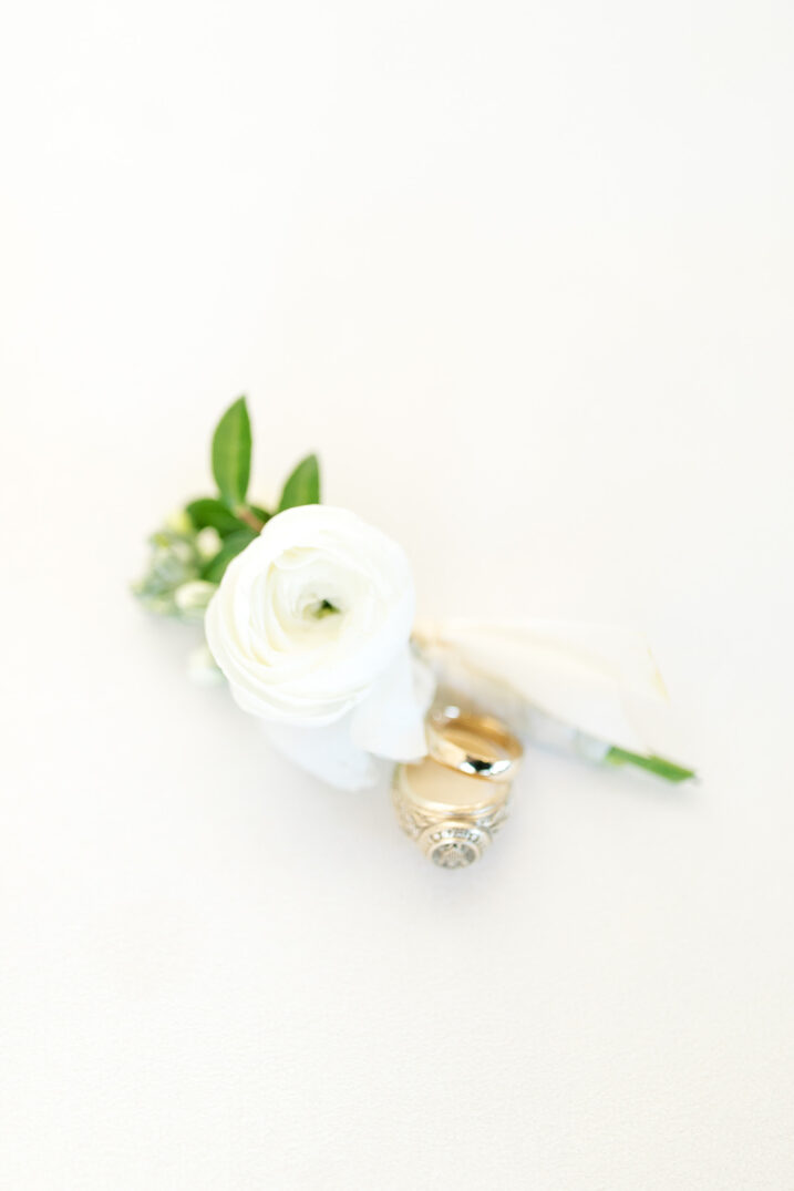 groom ring and boutonniere flatlay