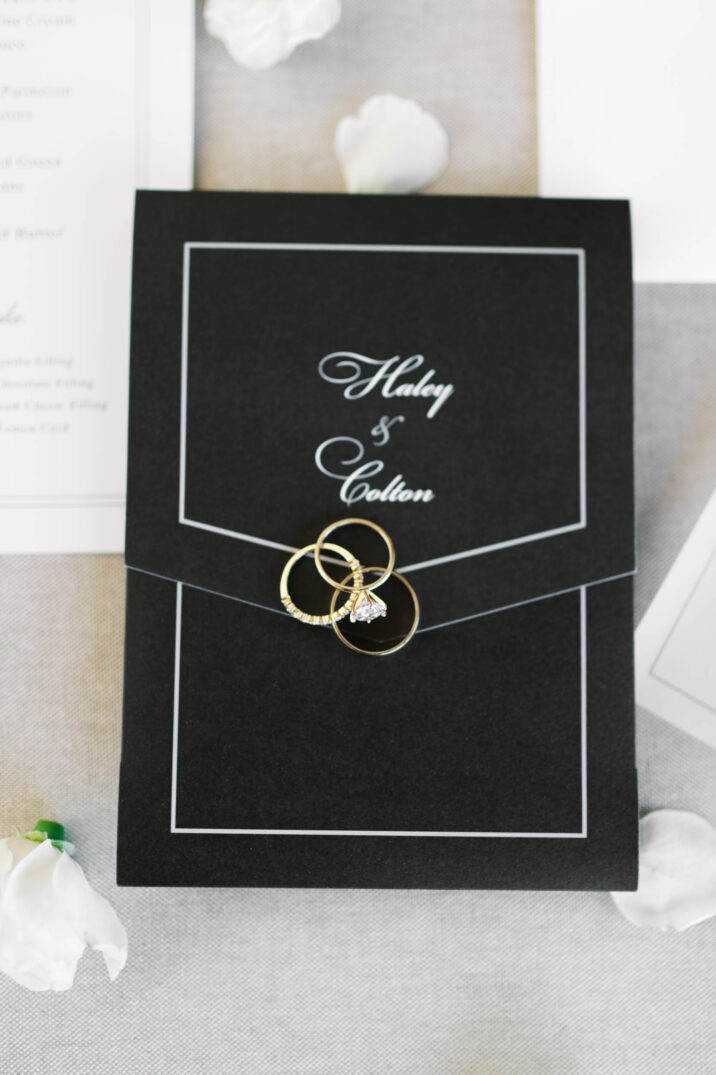 invitation and wedding ring and bands shot at The Luminaire