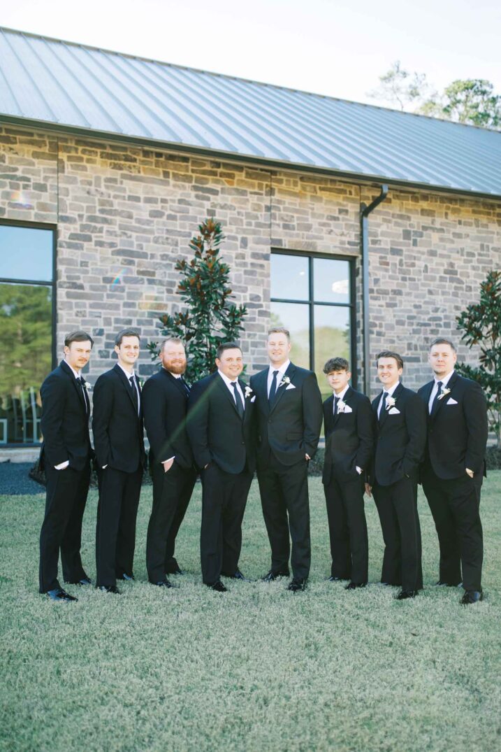 Houston winter wedding at The Luminaire with groomsmen classic white and black suits