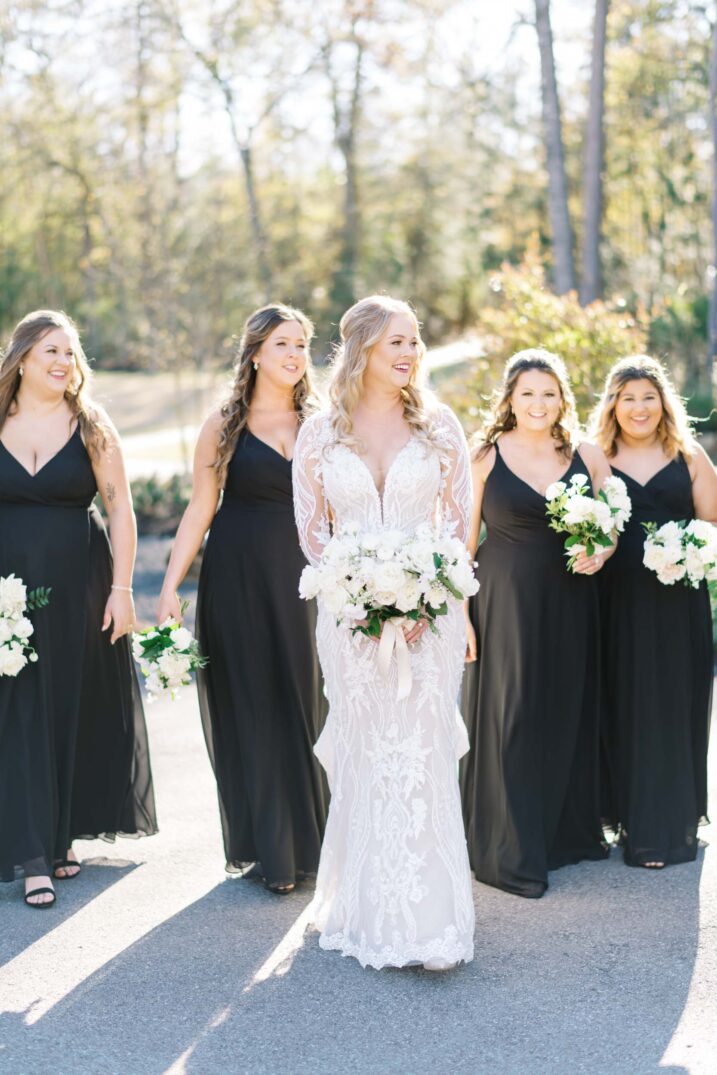 Houston winter wedding featuring classic black bridesmaid gowns