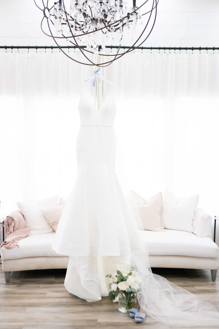 wedding dress hanging up inside bridal suite
