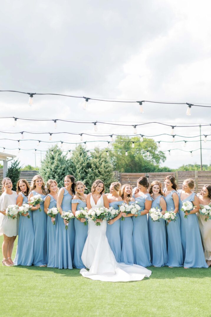 full bridal party at The Farmhouse wearing light blue dresses