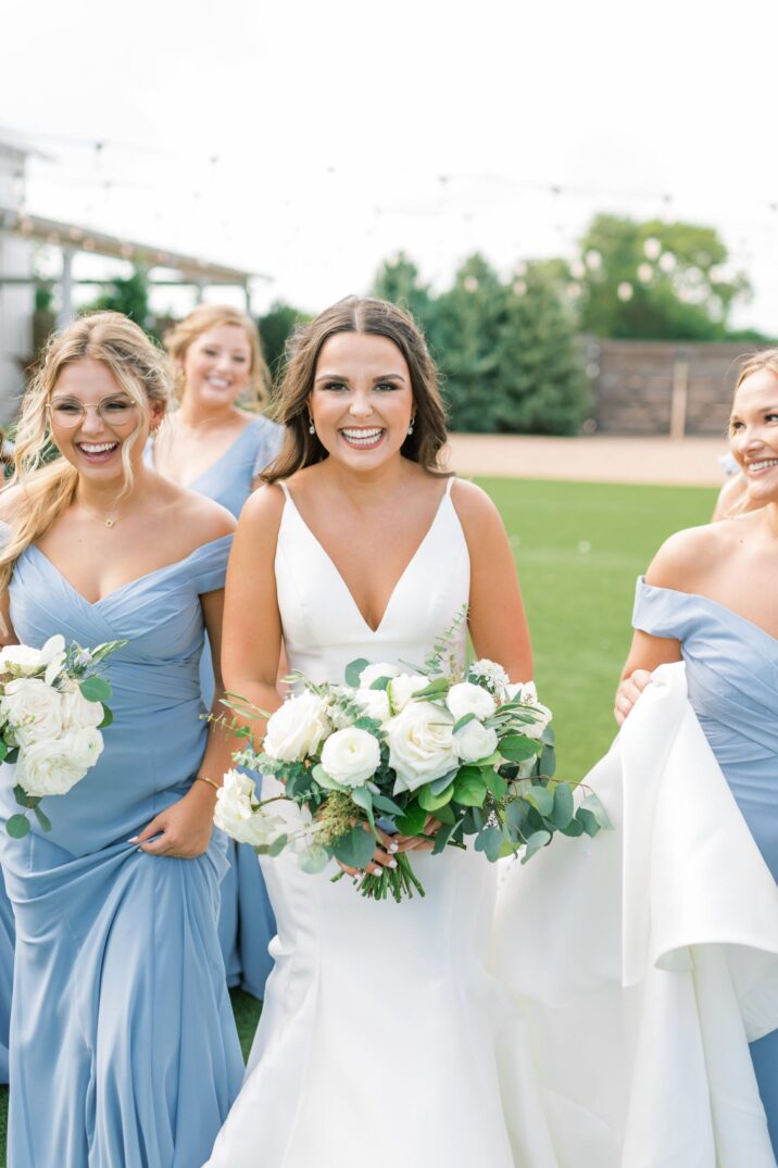 blue Houston modern wedding bride walking with her bridal party 