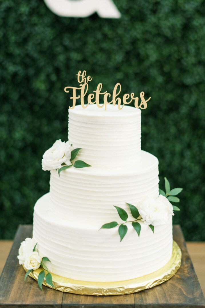 classic wedding cake with white roses and simple greenery