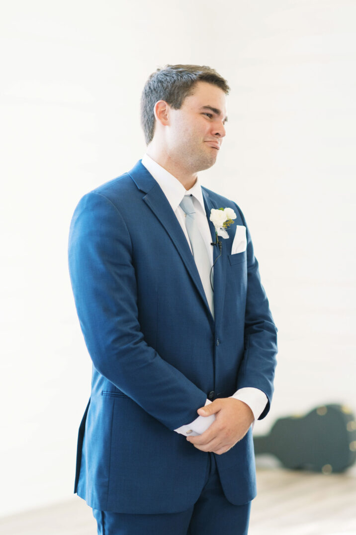 emotional groom during the ceremony for blue Houston modern wedding