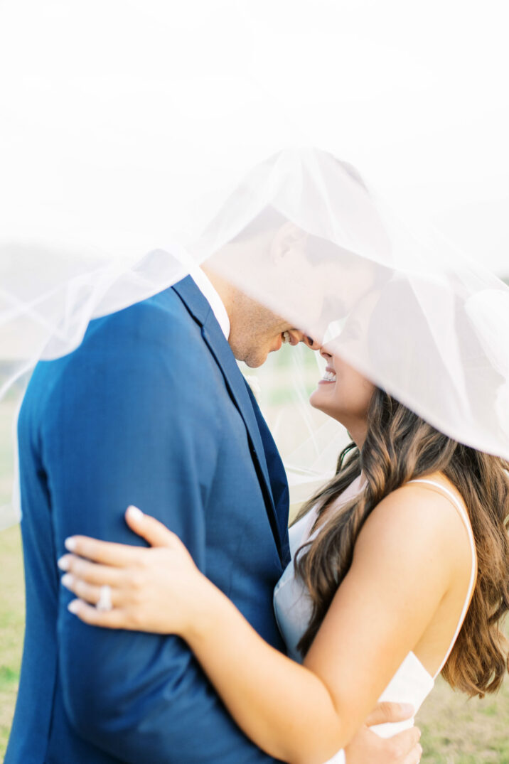 blue Houston modern wedding portraits with dramatic veil pose