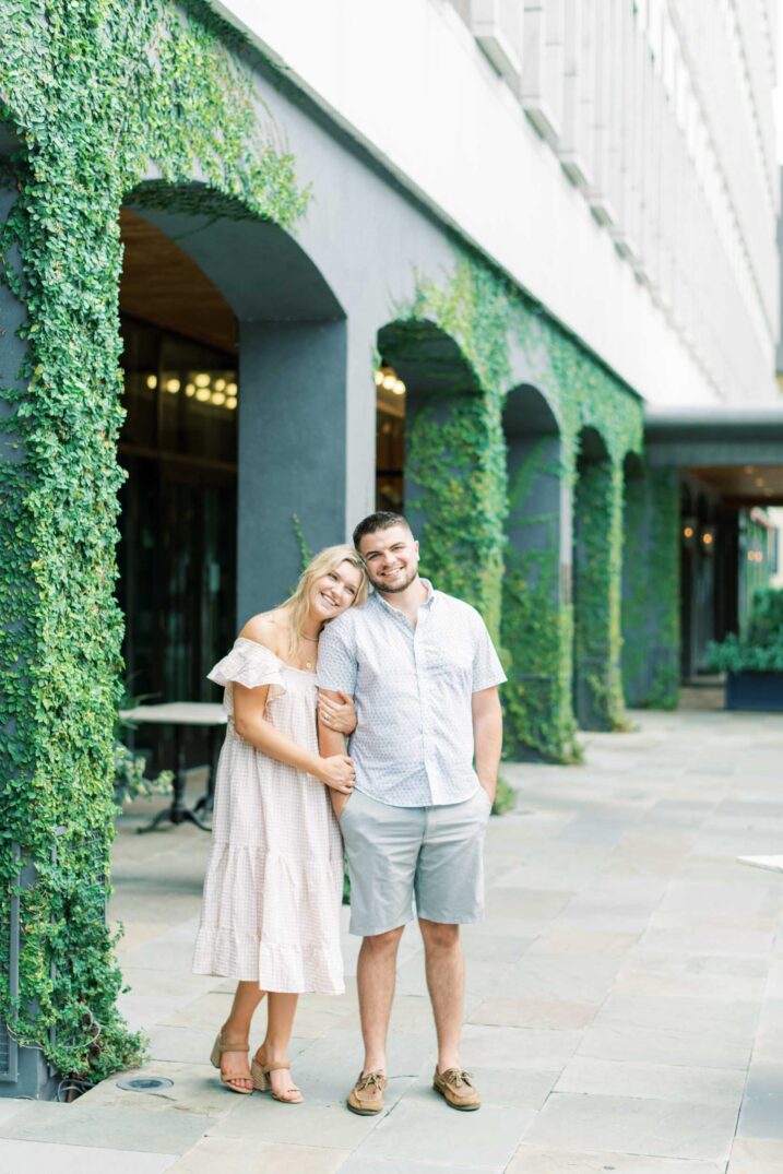 charleston engagement session with green vines on side of arched building