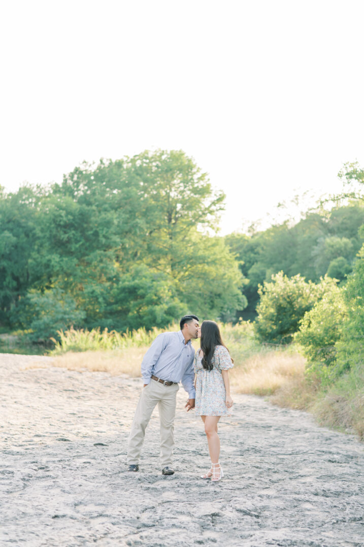 mckinney falls engagement couple kissing on special rocks