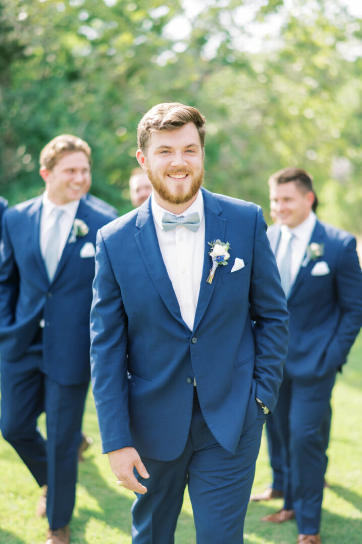 timeless texas spring wedding groom with groomsmen in the background