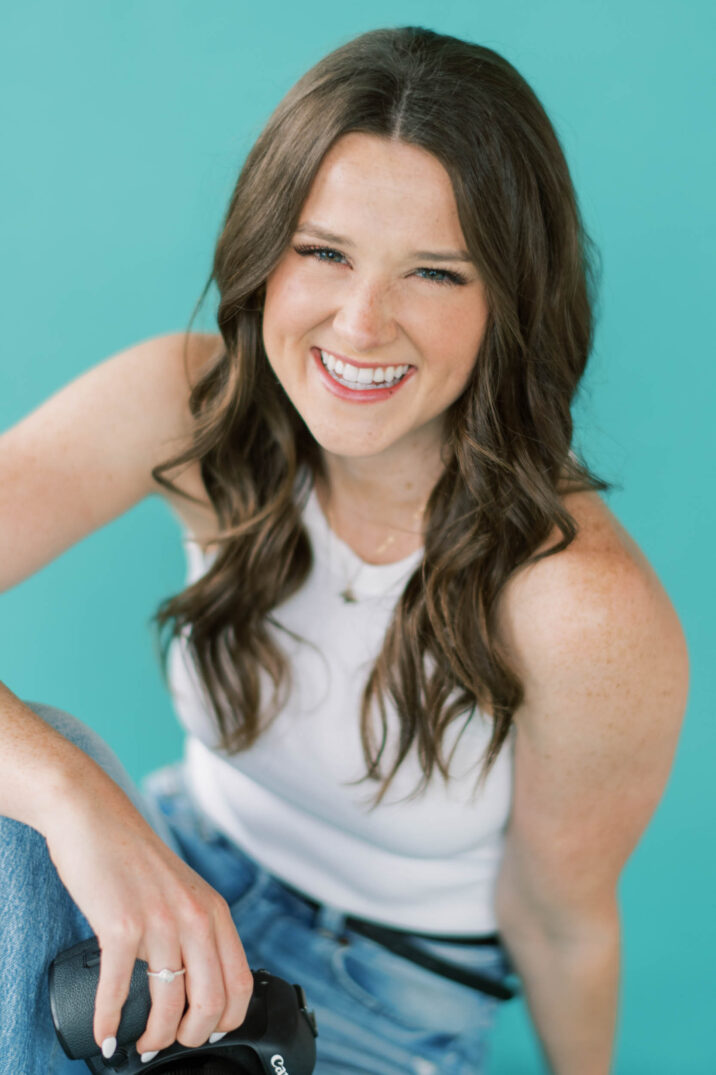 aqua background close headshot in casual jeans and white tanktop