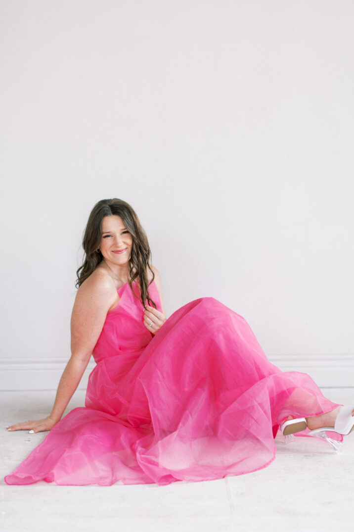 sitting in studio session with hot pink tulle dress