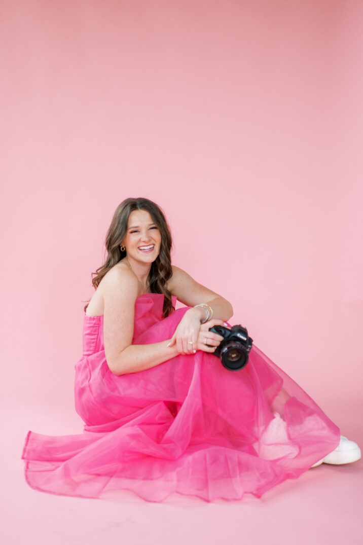photography business branding session headshot with bright pink background and pink dress