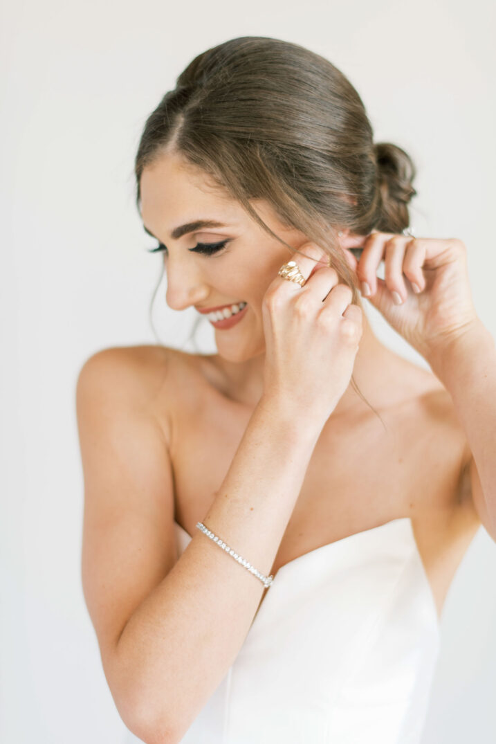 College Station modern bridals pose of putting earrings on