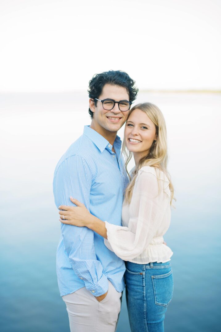 Dallas waterside engagement photos featuring bright blues and whties