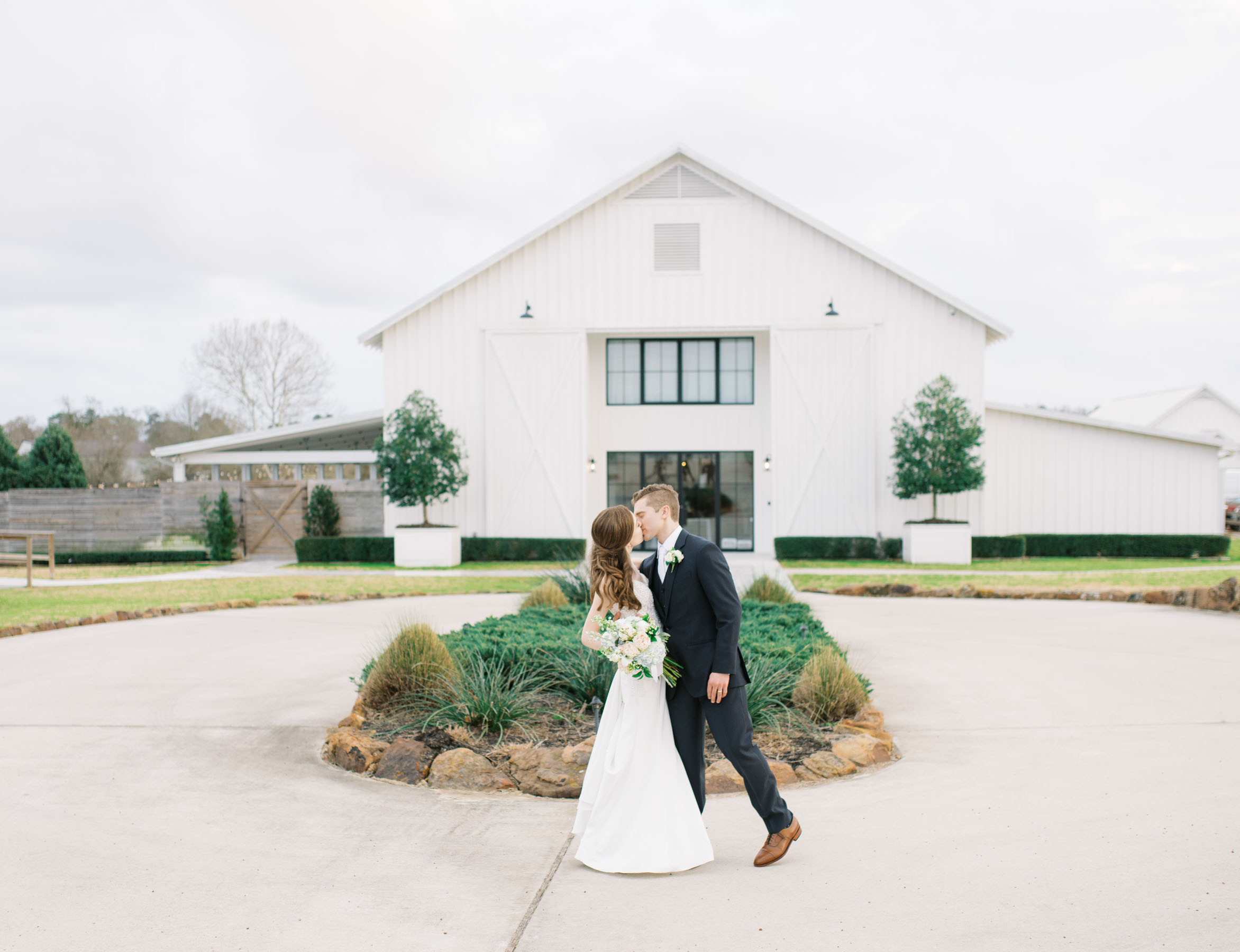 bride and groom outside The Farmhouse wedding venue in Houston, Texas