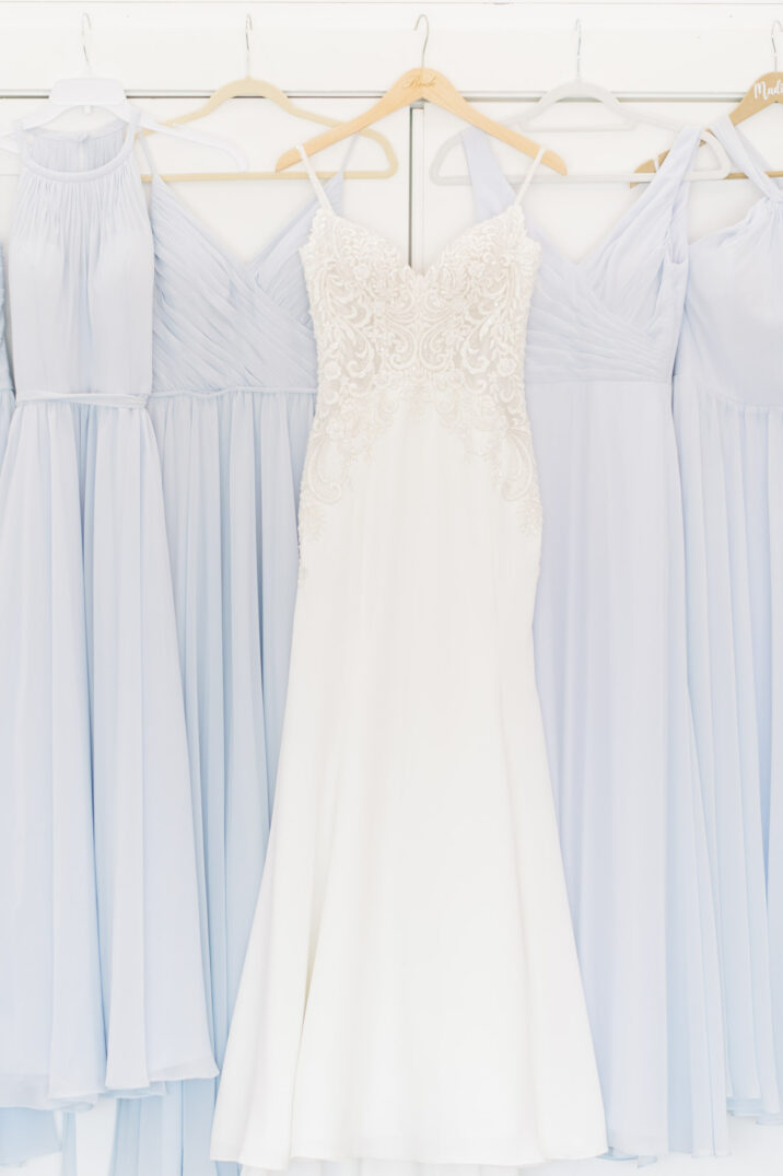 wedding dress and light blue bridesmaid dresses hanging up