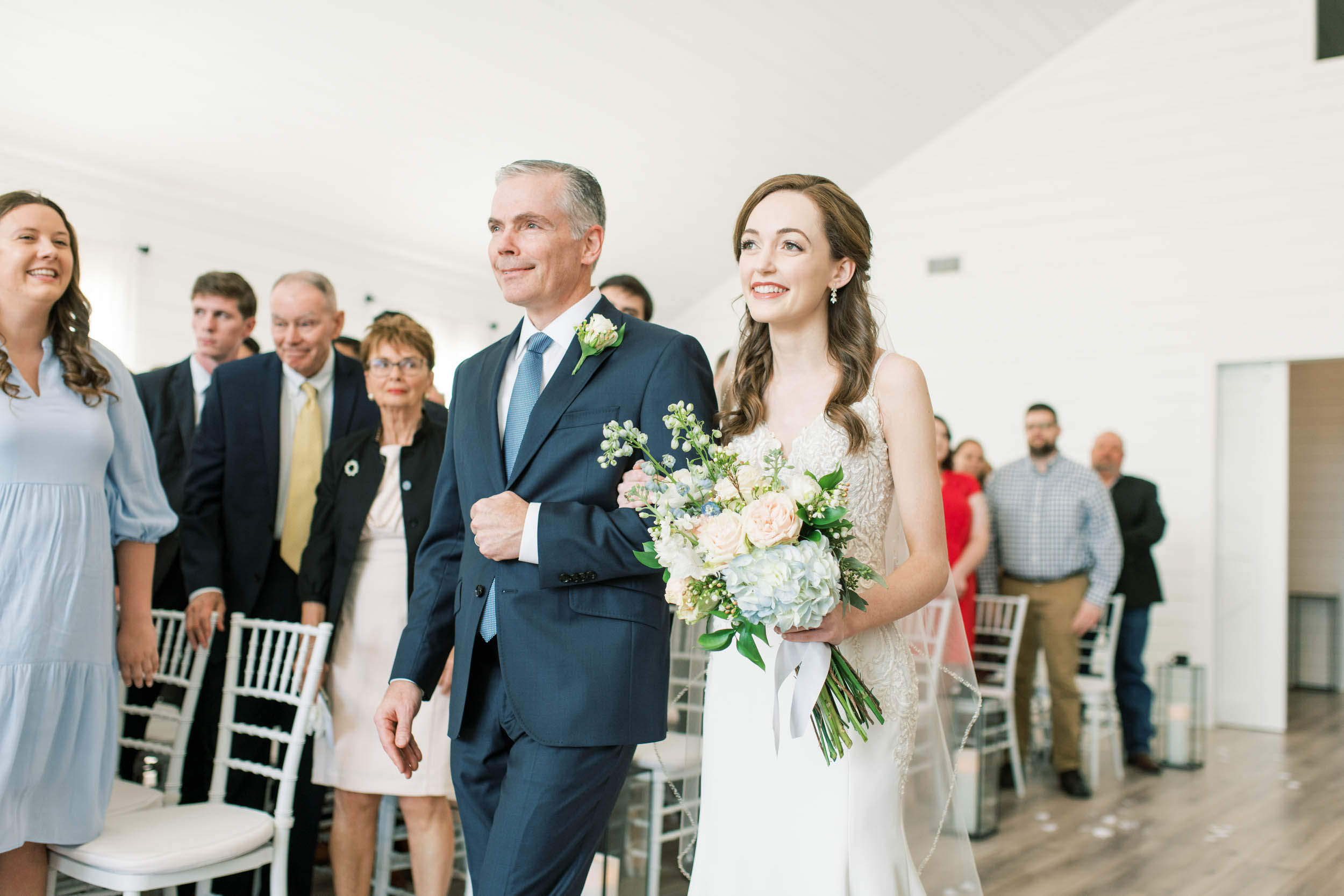 father of the bride and bride walking down the aisle at The Farmhouse venue