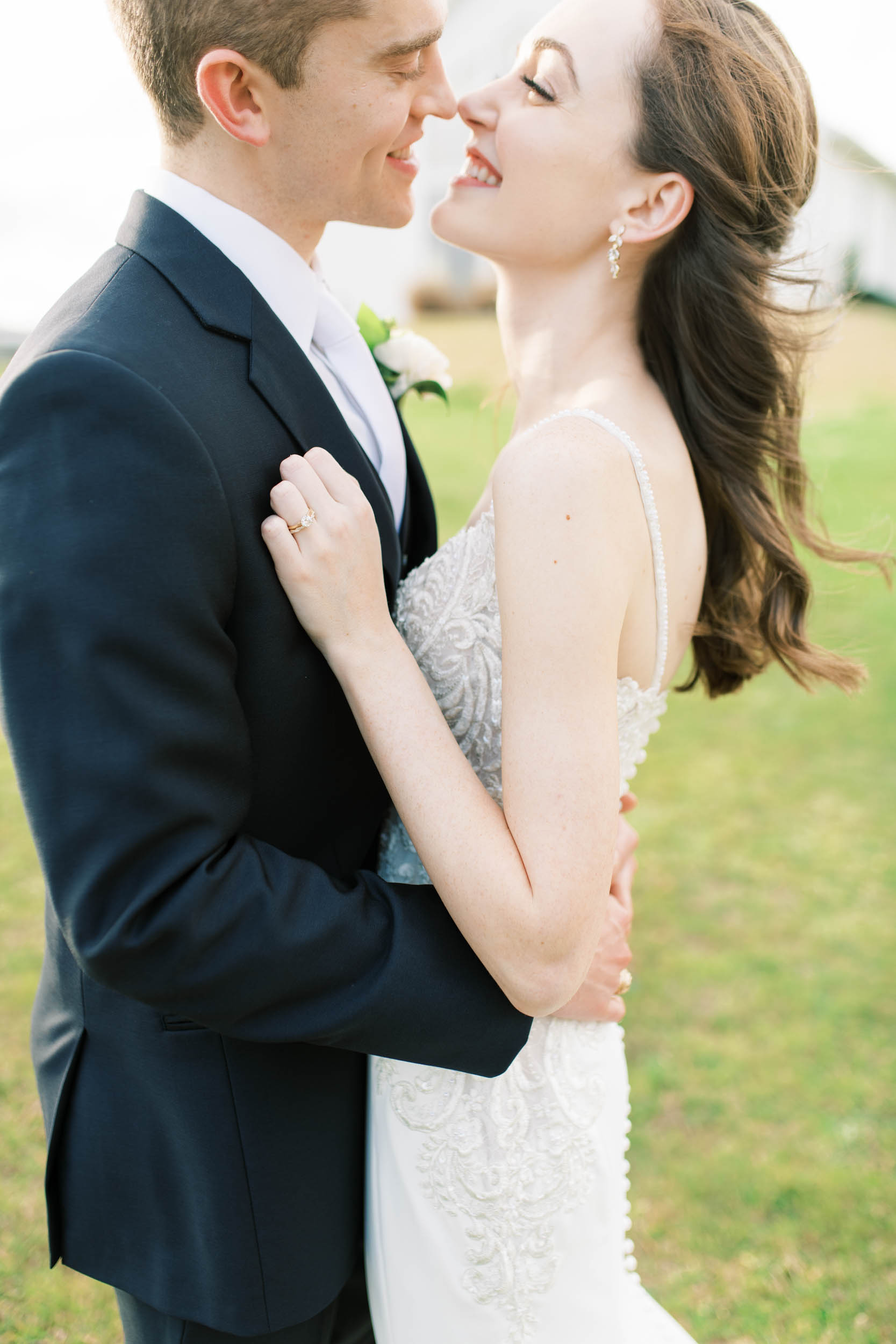 wedding couple touching noses in portraits outside The Farmhouse in Montgomery, Texas