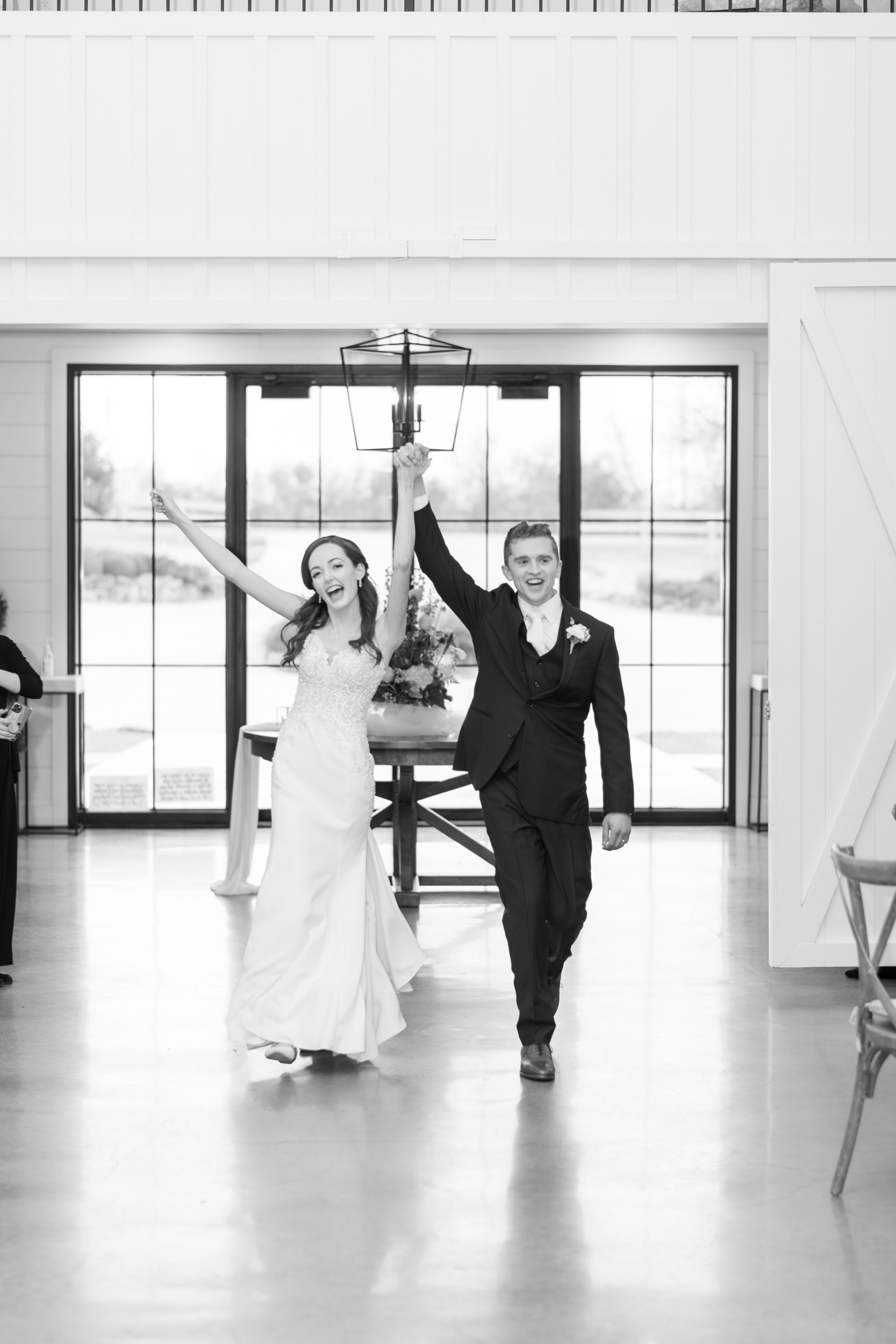 black and white wedding couple entering the reception area