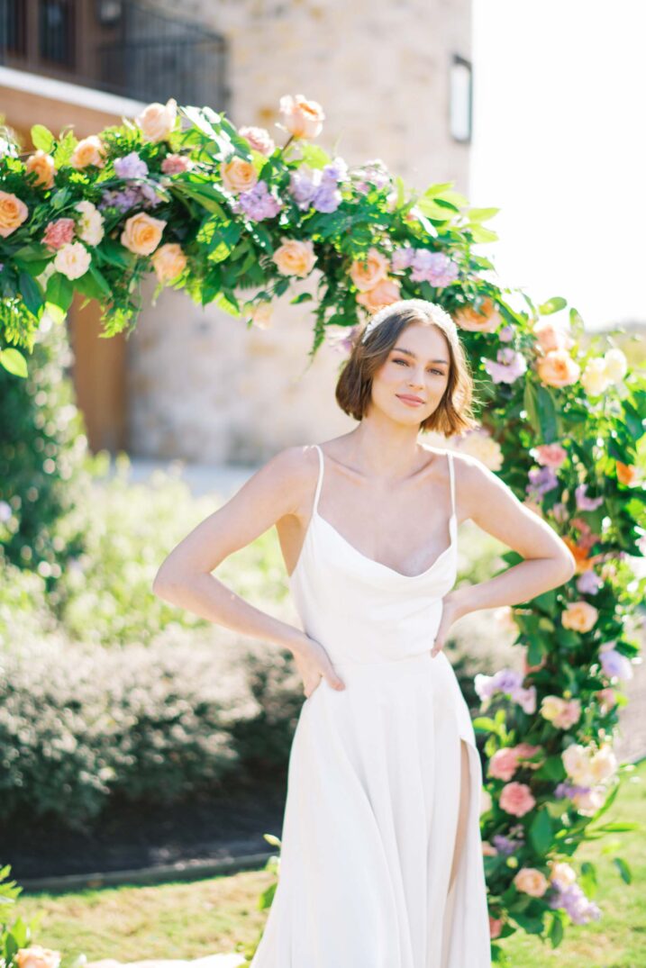 simple yet elegant wedding gown with a cowl neck featured with spring flowered archway