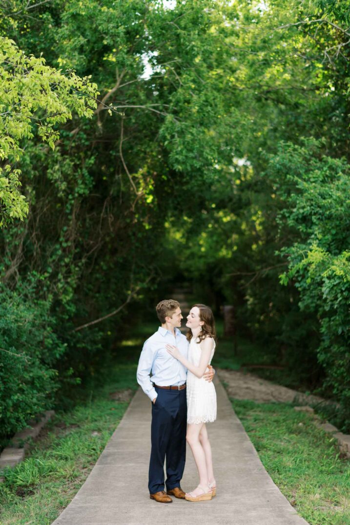 couple under tree covered nature path
