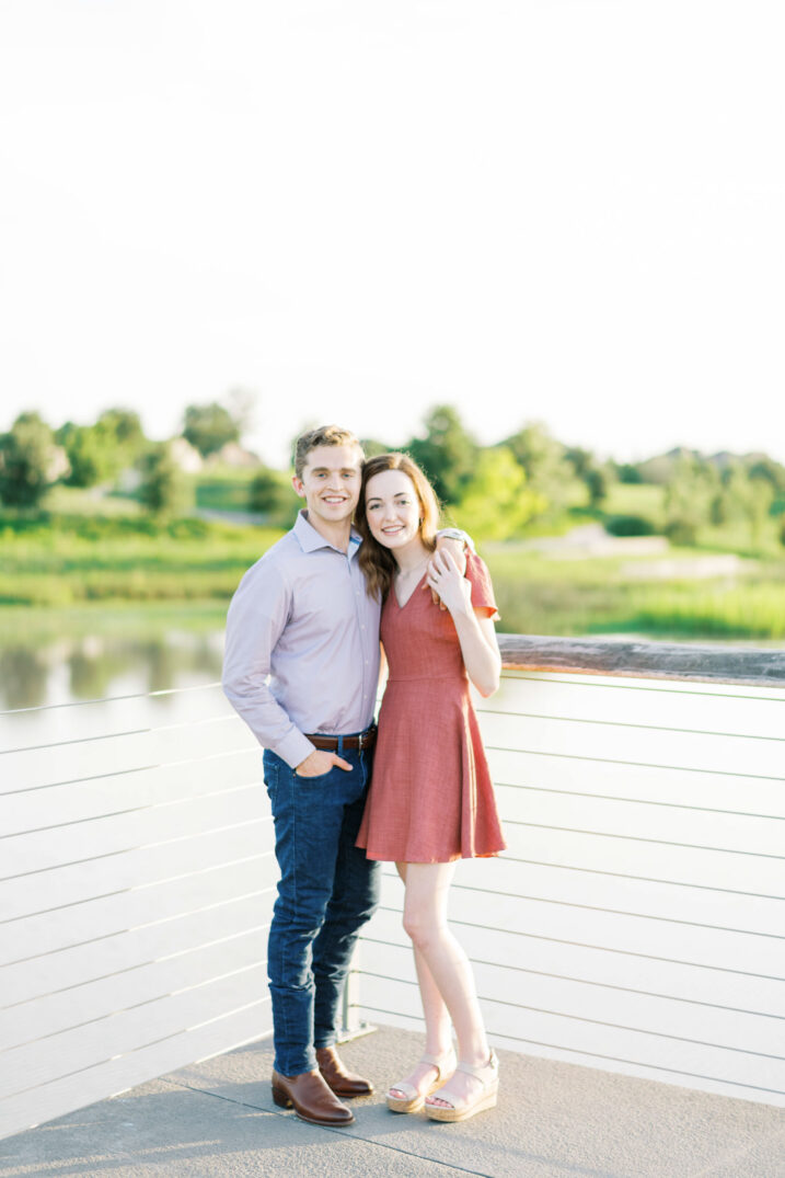 couple smiling in front of houston neighborhood lake