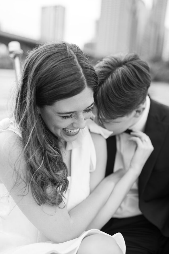 black and white engagement closeup of couple laughing 