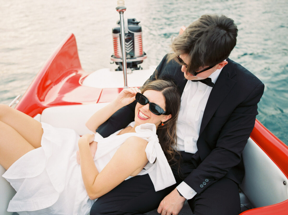 town lake engagement couple on a red boat