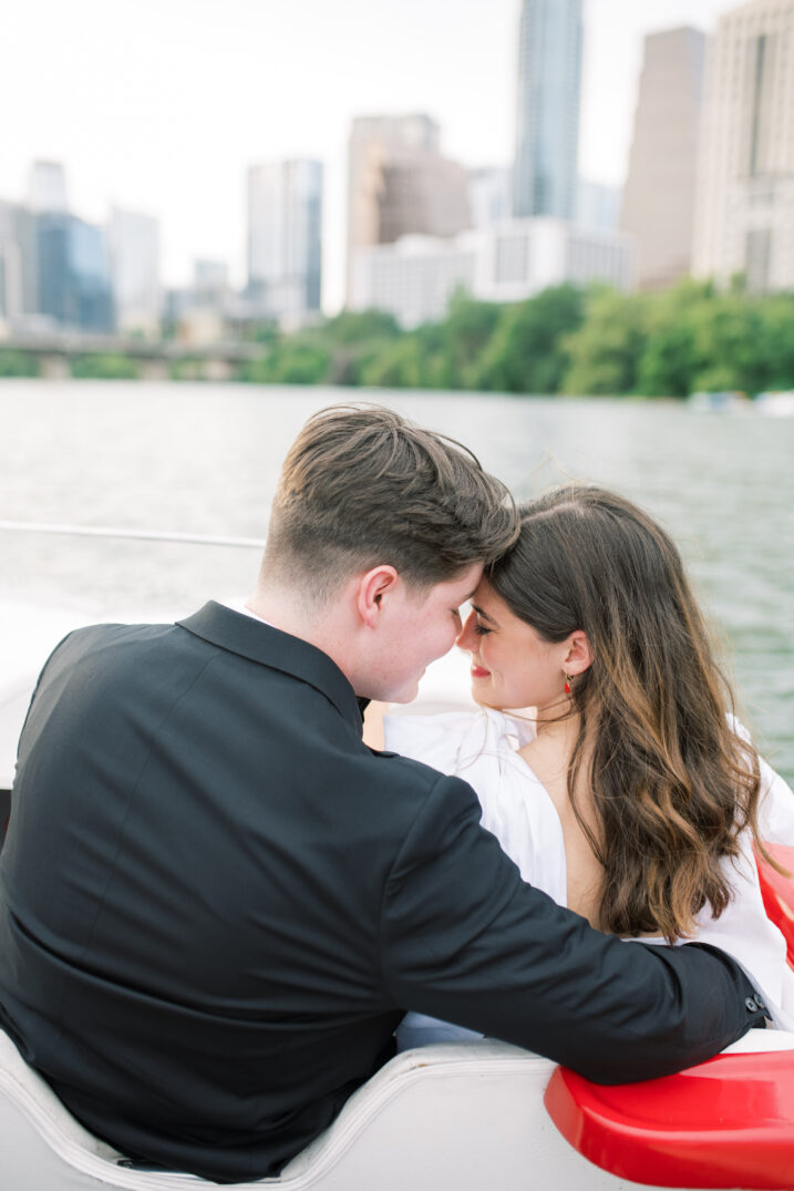 lake engagement with couple on a boat touching foreheads