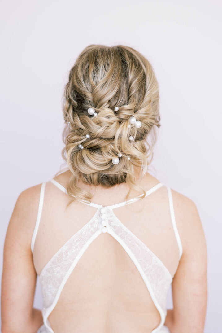 modern studio bridal session detailed back of wedding dress and pearl infused updo
