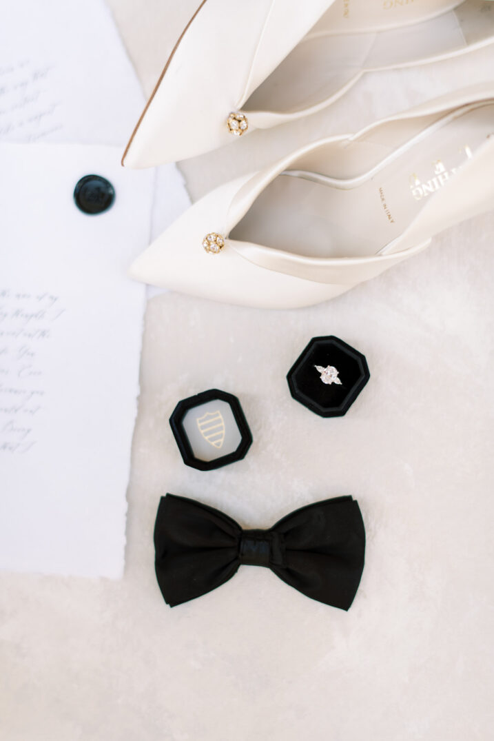 bride and groom wedding details shot with black bow tie and simple white close-toed heels
