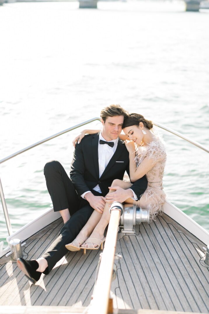 editorial portraits seine paris couple sitting on the front of a boat