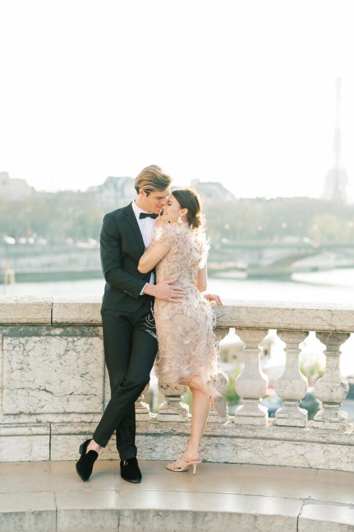 Parisian couple standing in front of the Seine River