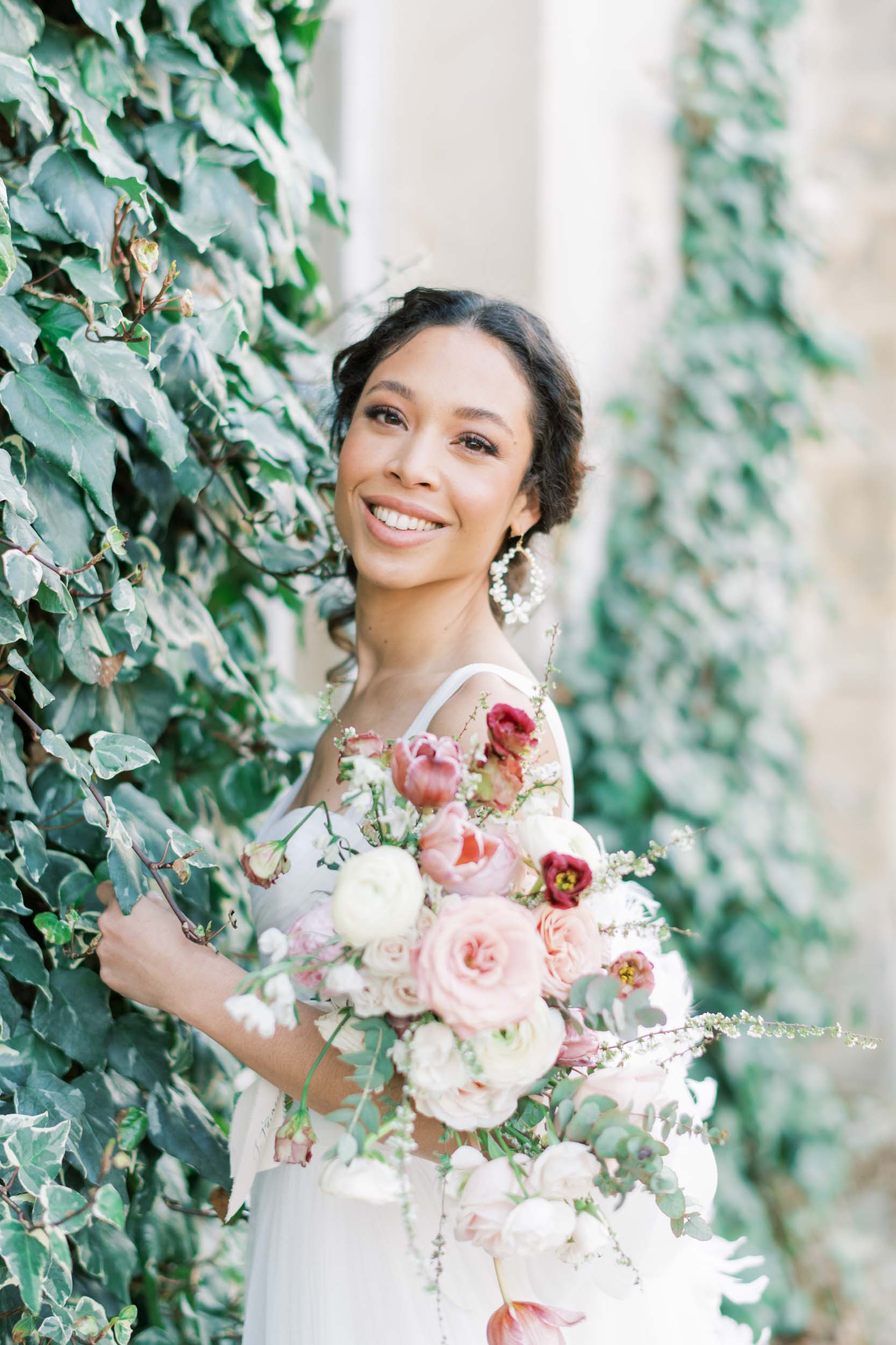 outdoor chateau bridal portraits featuring a wide array of pink and red flowers