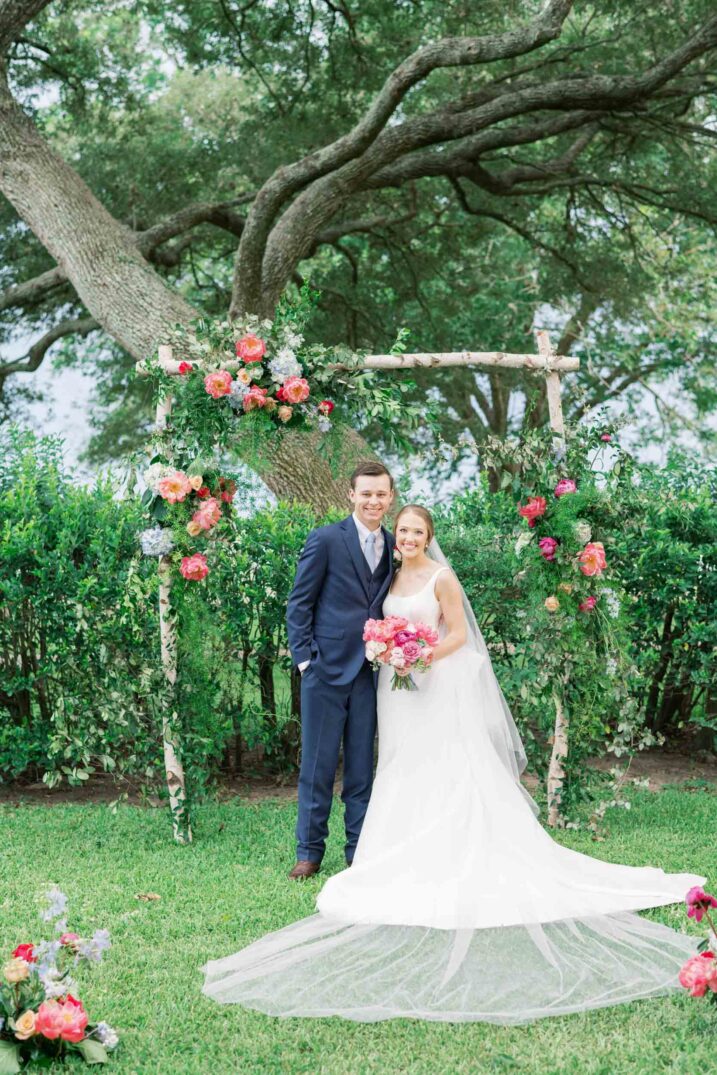 texas hill country luxury wedding portrait of bride and groom at outdoor ceremony altar