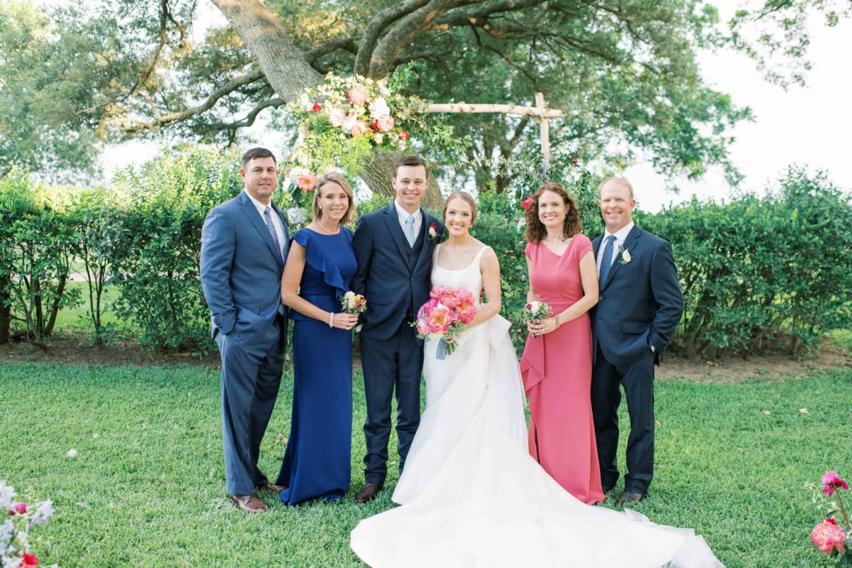 parents with bride and groom in Victoria, Texas backyard wedding