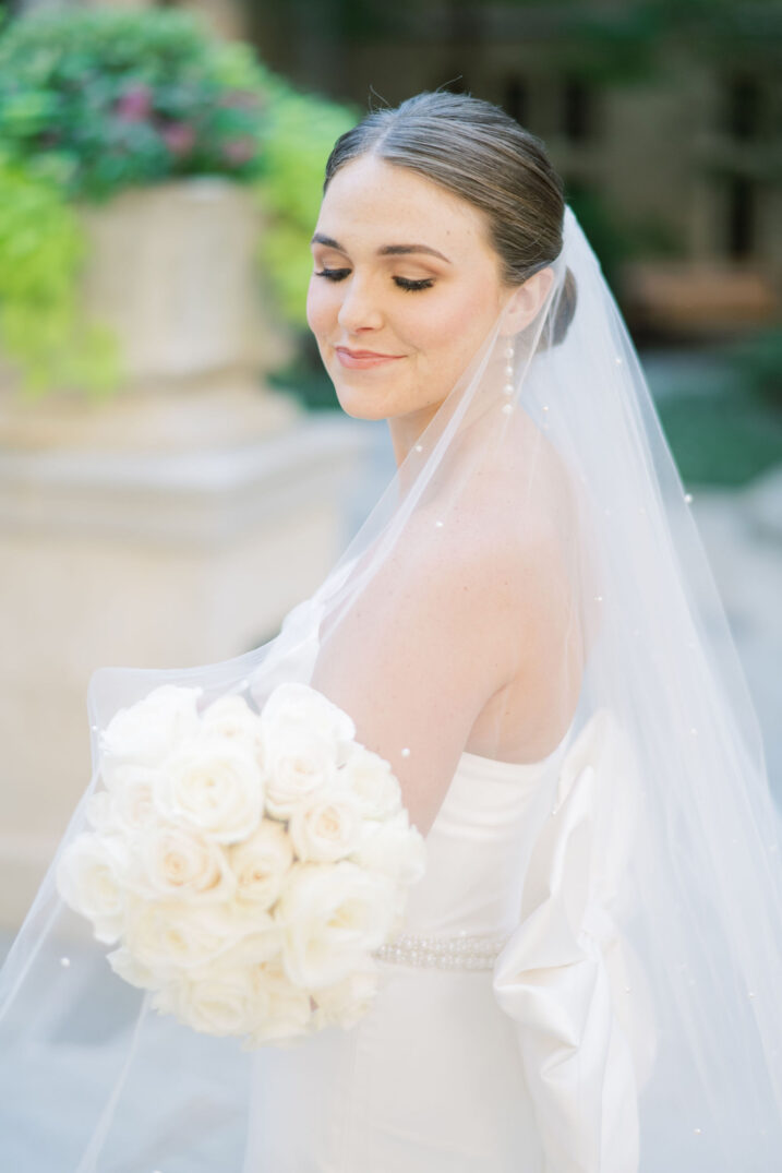 elegant country club bridals with pearly veil and an all white rose bouquet