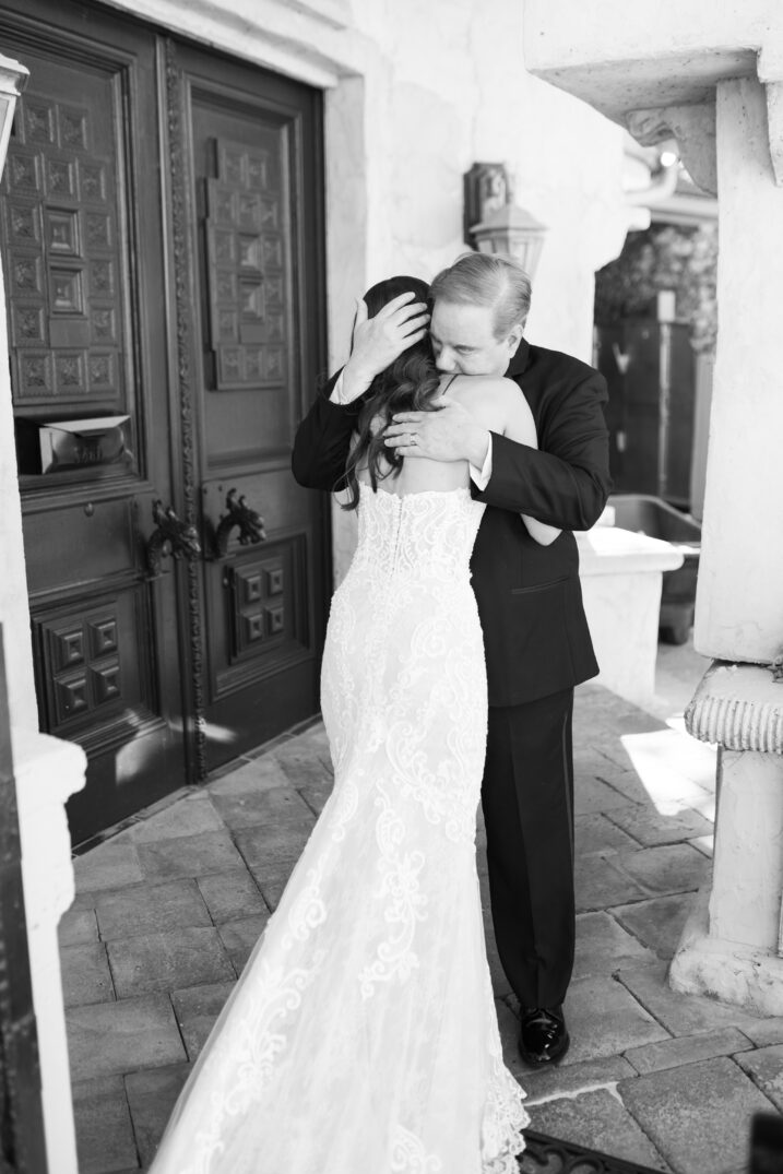 black and white mother of the bride first look hug 