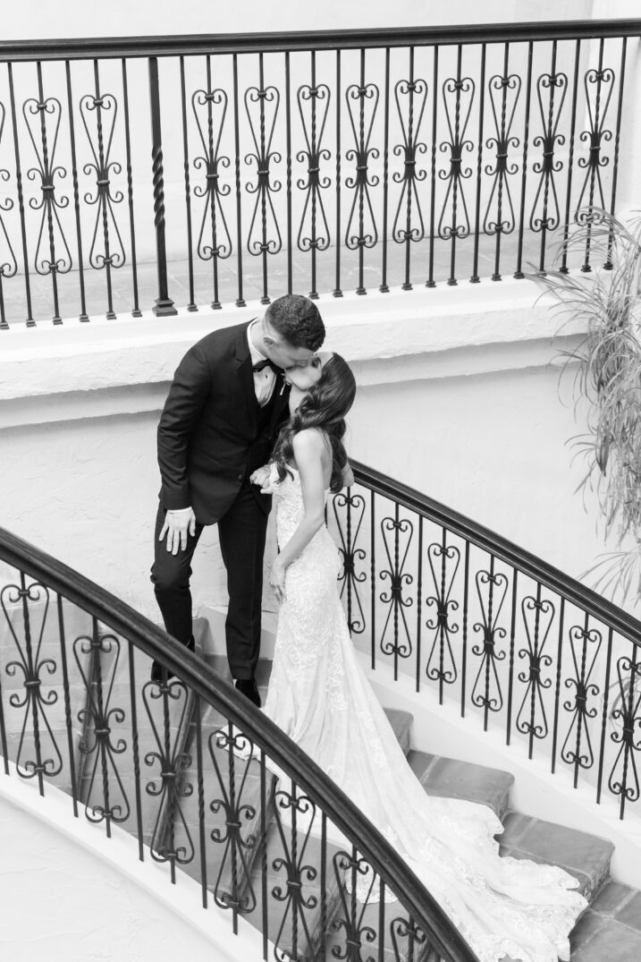 bride and groom kissing staircase black and white Italian inspired wedding high-end