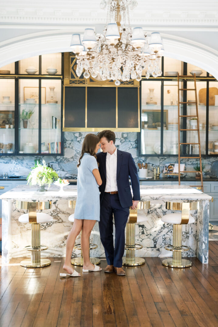 engaged couple standing in front of a bar