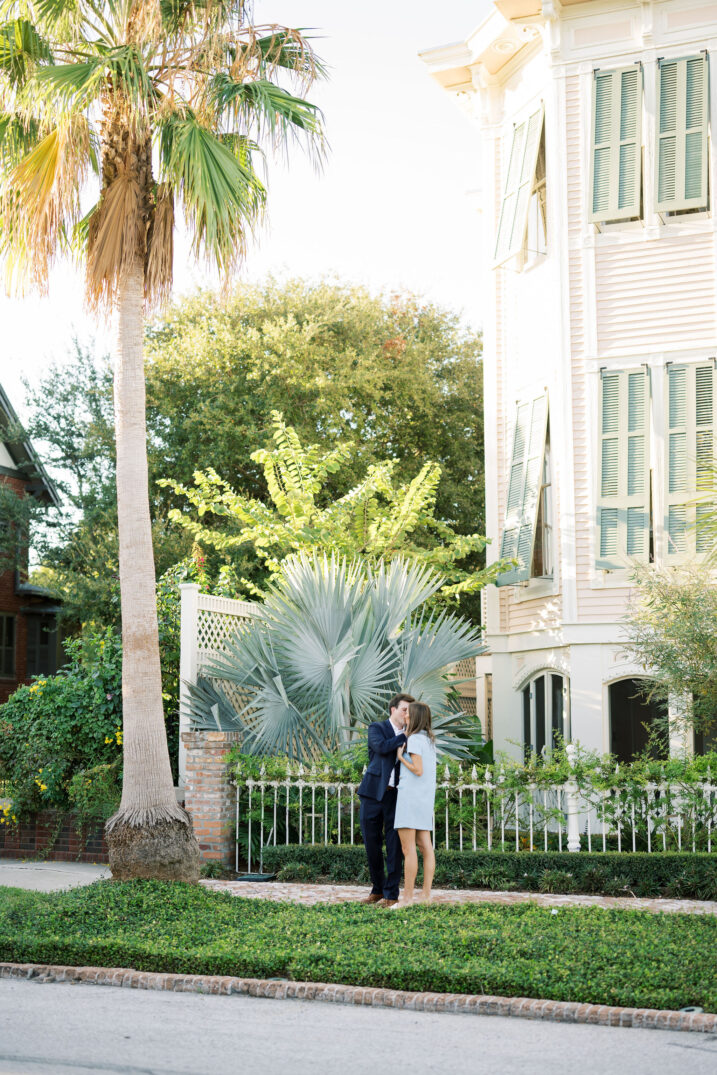 boy and girl kissing under palm tree