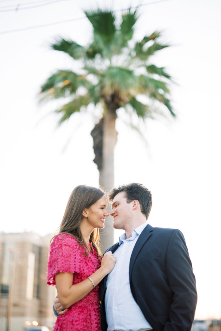 engaged couple under palm tree