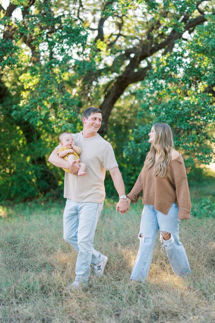 mom and dad walking with baby