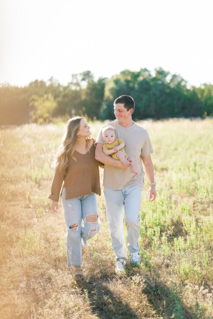 mom and dad walking with baby