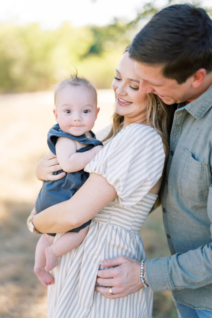 parents looking at baby